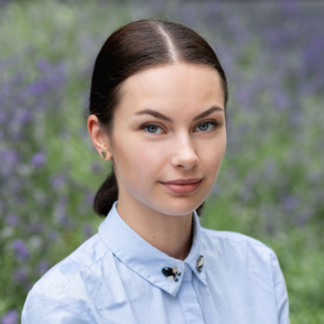 Headshot of Daryna Kadurina, a women with brown hair and blue eyes.